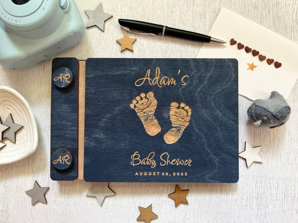 Baby shower guest book with footprints and personalized text on a wooden covers- with a navy wood stain and engraved baby foot prints with personalized text