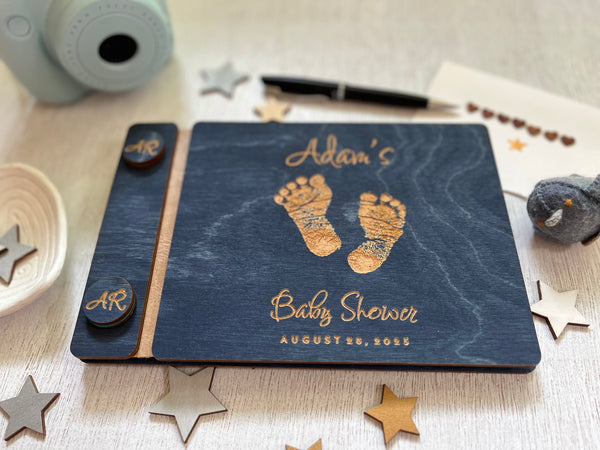 Baby shower guest book with footprints and personalized text on a wooden covers- with a navy wood stain and engraved baby foot prints with personalized text