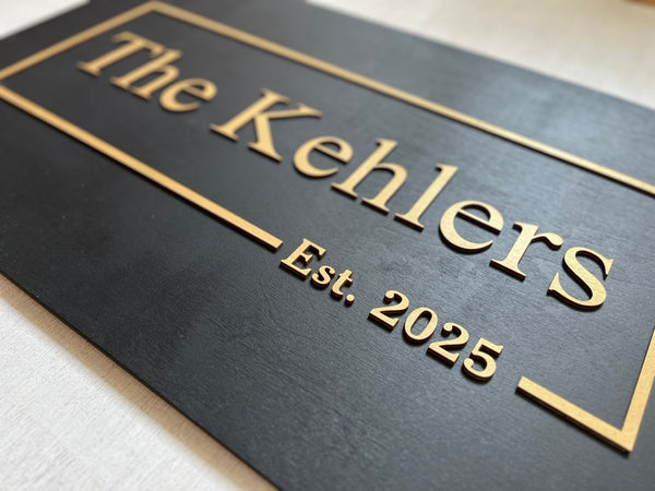 Black plaque with 'personalized name and established date - text in gold on a black background