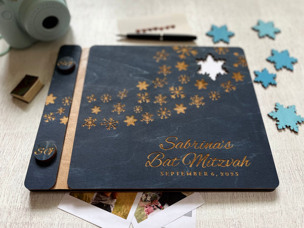 Personalized Bat Mitzvah guest book album with decorative engraved snowflakes on a navy wooden cover