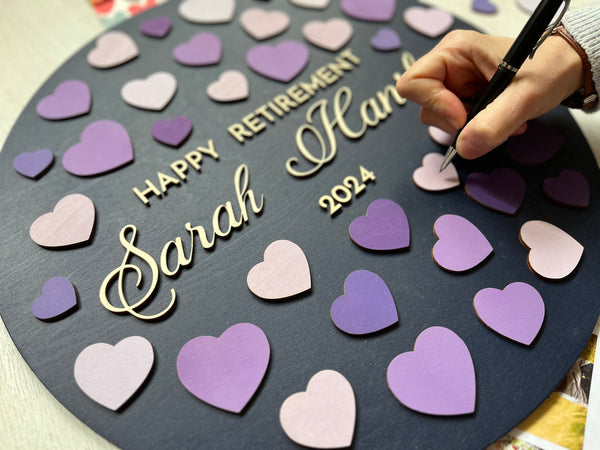 hand signing a heart on this retirement guest book personalized and customized for your soon to be ex coworker