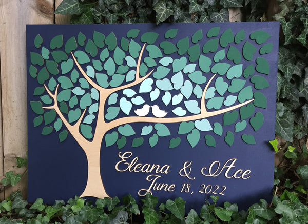 3D wedding guest book with green ombre leaves set in a natural environment to show the simplicity and elegance of the color scheme