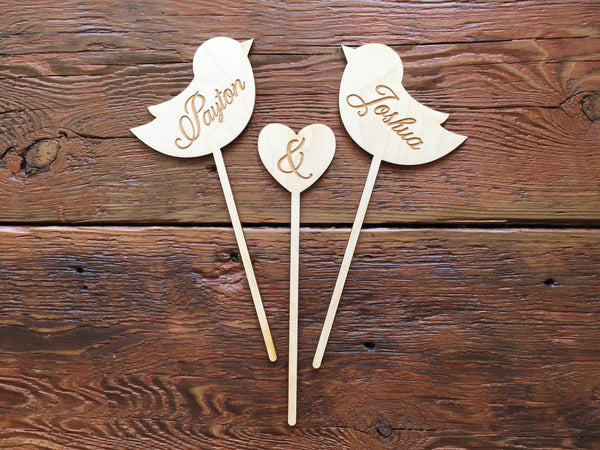 Wooden wedding cake topper with love birds and heart engraved with personalized couple's name