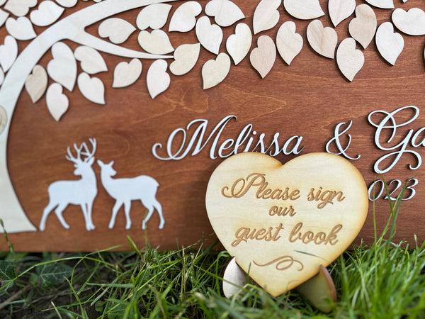 the guest book can be accompanied by a heart shaped sign to ask guests to sign