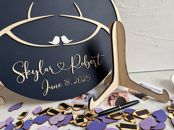 The round magnetic wedding guest book comes with two trees, birds, magnetic leaves for guests to sign as well as a stand and a hanger at the back of the board. The board is personalized with the names of the bride and groom and wedding date. 