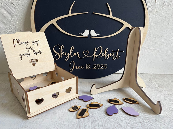 The magnetic guest book comes with a stand, hanger, personalized names, two trees and birds in the tree, plus an optional box that can host the magnetic leaves.