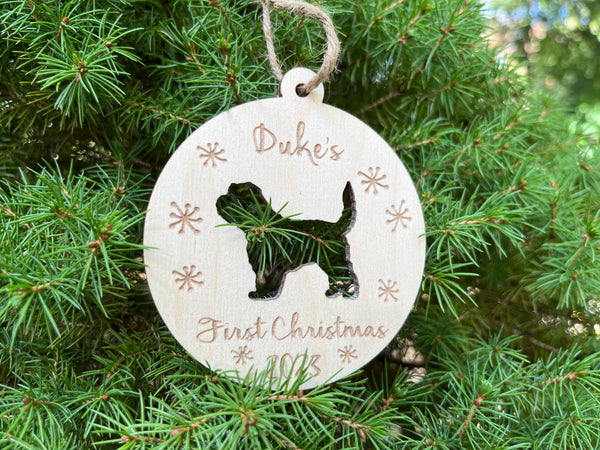 personalized doodle puppy first Christmas ornament with the name of the puppy and a golden doodle silhouette shown displayed on a fir tree