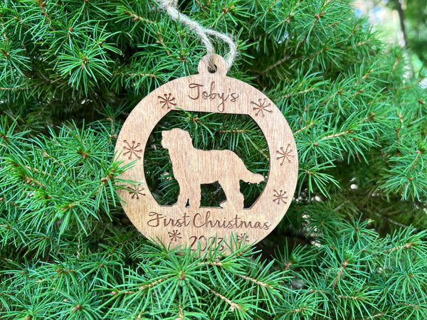 personalized puppy's first Christmas ornament round with golden doodle silhouette on a brown stain wood