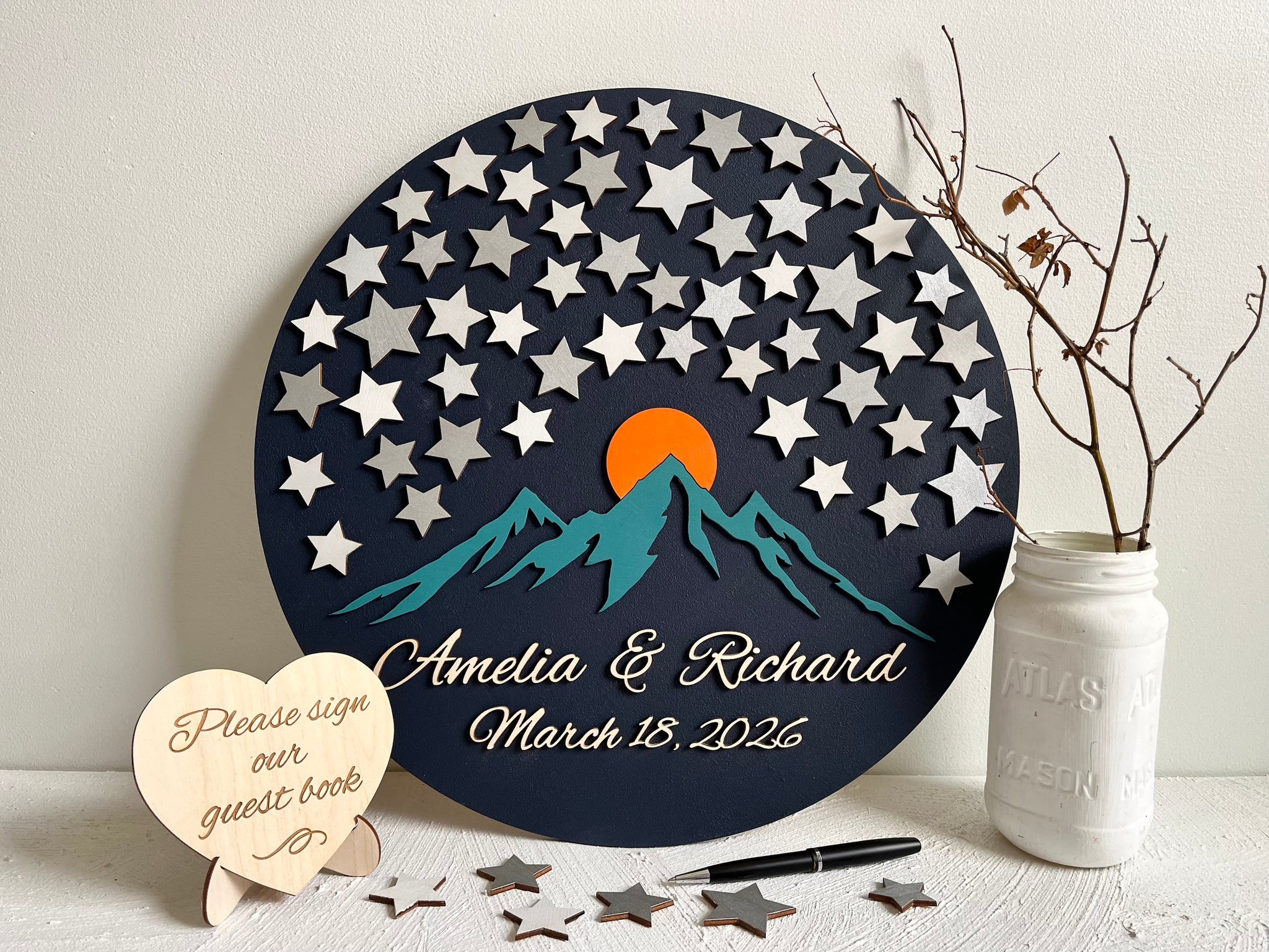 Decorative guest book with star pattern, mountains, and sunset design - round sign with stars for guests to sign