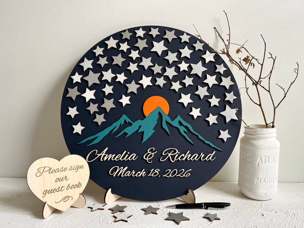 Decorative guest book with star pattern, mountain design, and personalized text. 