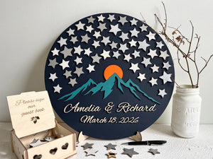 Round wedding guest book alternative with star pattern, mountains, and personalized text displayed on a wooden stand. The guest book board is magnetic and the stars can be removed and added or rearranged on the board. 