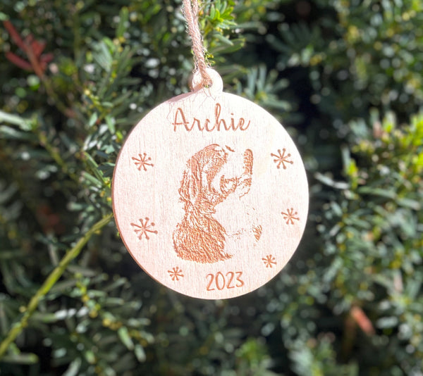 a Berner pup's portrait engraved on a Christmas tree ornament