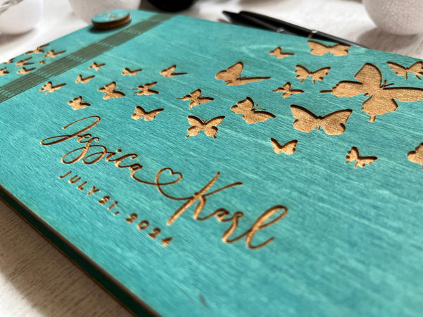 detail to show the font for the names of the couple and the butterflies engraved on a teal wood stain signyoustyle.com