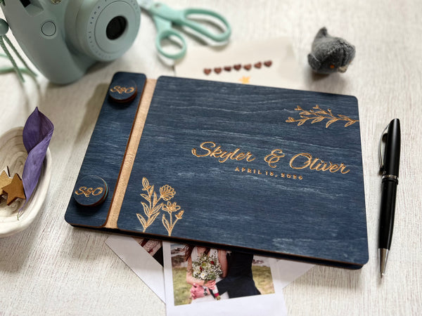 Personalized guest book with decorative floral elements with wooden engraved covers with a navy wood stain. Add your names and wedding or bachelorette party date. Customize the cover colors 