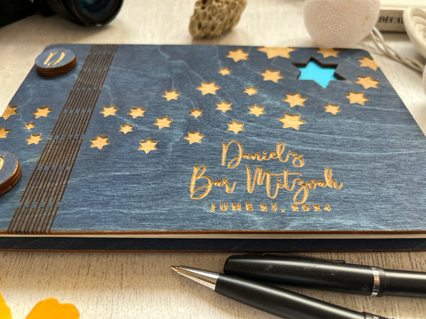 the guest book is made with a navy wood stain and a blue Star of David motif