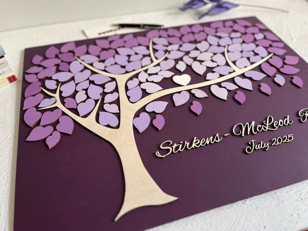 Decorative family tree guest book with purple leaf design for a family reunion 