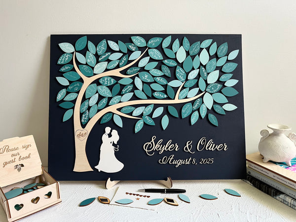 magnetic guest book alternative puzzle made for wedding with personalized names of the bride and groom and wedding date, with magnetic leaves for each guest to sign. The guest book also comes with a holder and an optional box to store the leaves. The top of the box contains the text "Please sign our guest book".