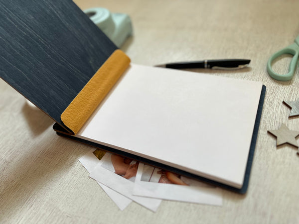 Personalized guest book with decorative floral elements with wooden engraved covers with a navy wood stain. Add your names and wedding or bachelorette party date. Customize the cover colors 