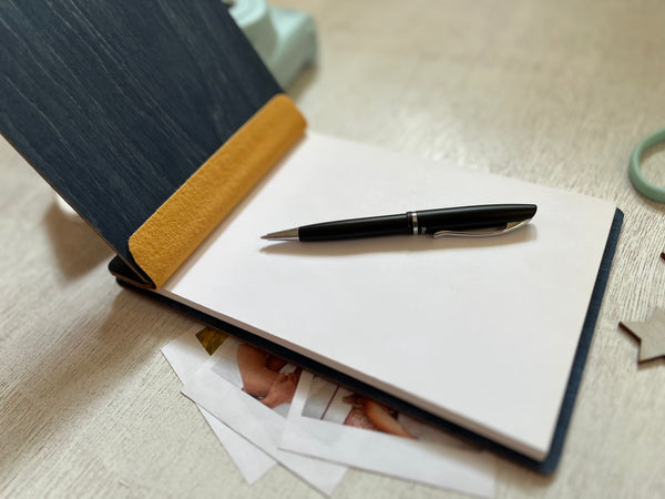 Notebook with a pen on a textured surface