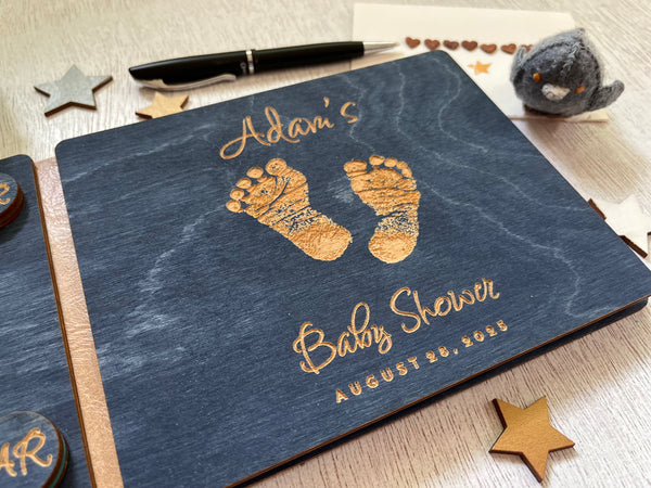 Baby shower guest book with footprints and personalized text on a wooden covers- with a navy wood stain and engraved baby foot prints with personalized text 