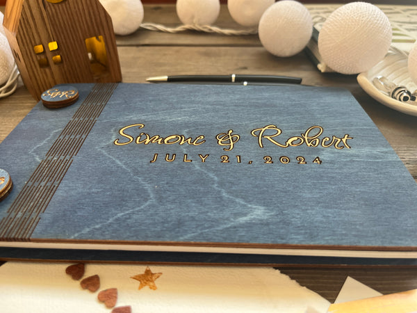 detail of navy guest book with gold lettering