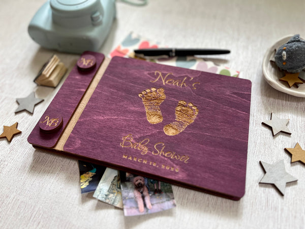 Baby shower guest book with footprints and personalized text on a wooden covers- with a violet wood stain and engraved baby foot prints with personalized text 