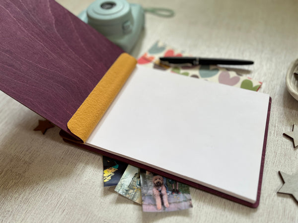 open Baby shower guest book with footprints and personalized text on a wooden covers- with a violet wood stain and engraved baby foot prints with personalized text 