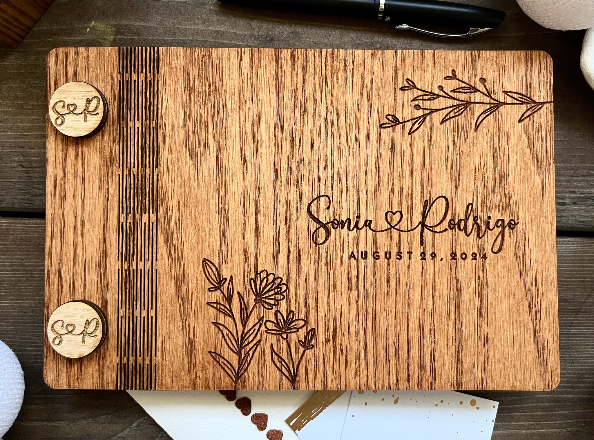 rustic wedding guest book album with custom engraved details and floral motif
