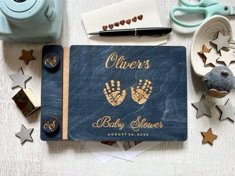 Baby shower guest book with handprints with personalized name and buttons, made of wood with a navy blue stain and engraved handprints