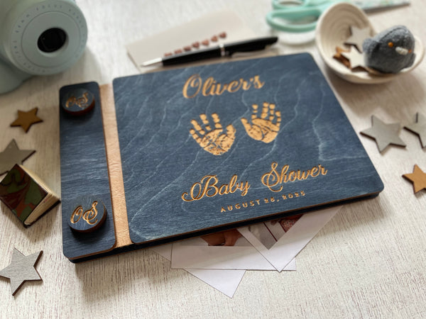 baby shower guest book with handprints with personalized name and buttons, made of wood with a navy blue stain and engraved handprints