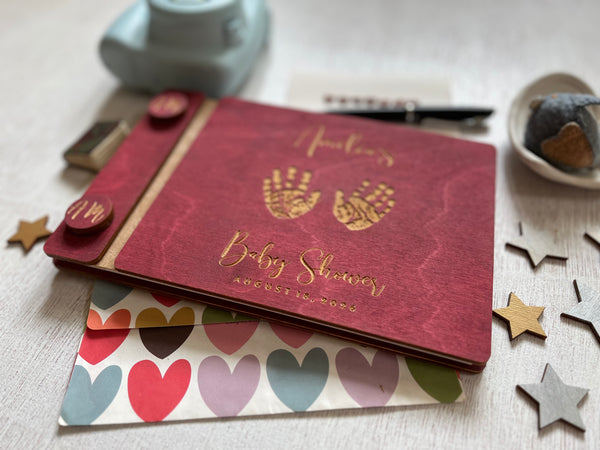baby shower guest book with handprints with personalized name and buttons, made of wood with a burgundy stain and engraved handprints