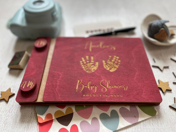 baby shower guest book with handprints with personalized name and buttons, made of wood with a burgundy stain and engraved handprints