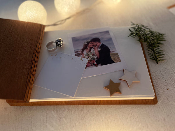 detail of wedding guest book album with polaroids photobook scrapbook