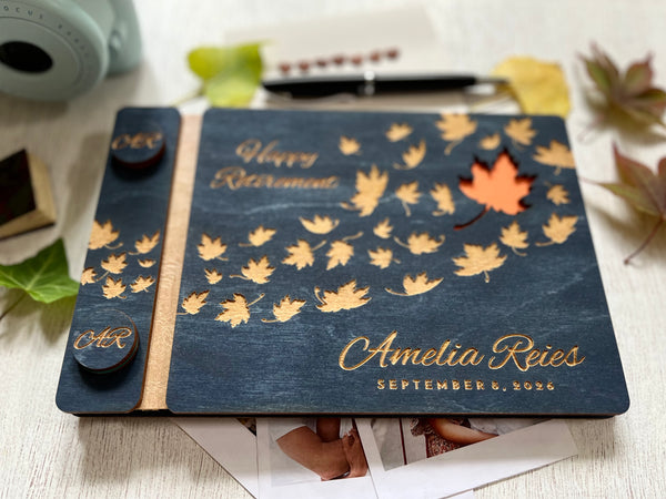 Personalized retirement guest book with autumn leaf design on a custom engraved surface with maple leaves and  personalized with the name of the retiree and the text "Happy Retirement"