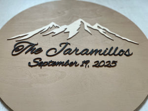 Personalized wooden plaque with mountain design and text on a beige background