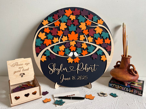 Magnetic guest book with maple leaves for wedding guests to sign  and personalized text, with a holder and box for the leaves