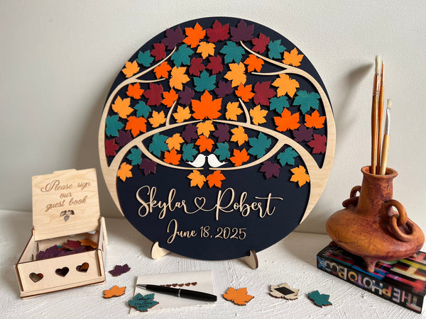 Magnetic guest book with maple leaves for wedding guests to sign  and personalized text, with a holder and box for the leaves
