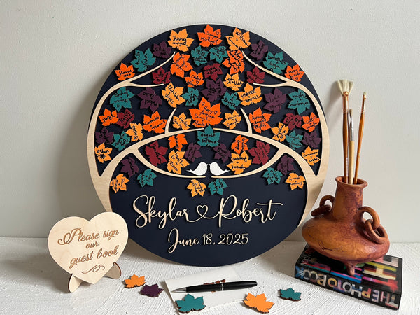 Decorative wedding guest book with colorful maple leaf pattern and personalized text - with signatures from wedding guests on each maple leaf