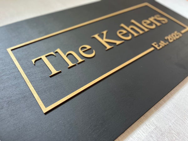 Black plaque with 'personalized name and established date - text in gold on a black background