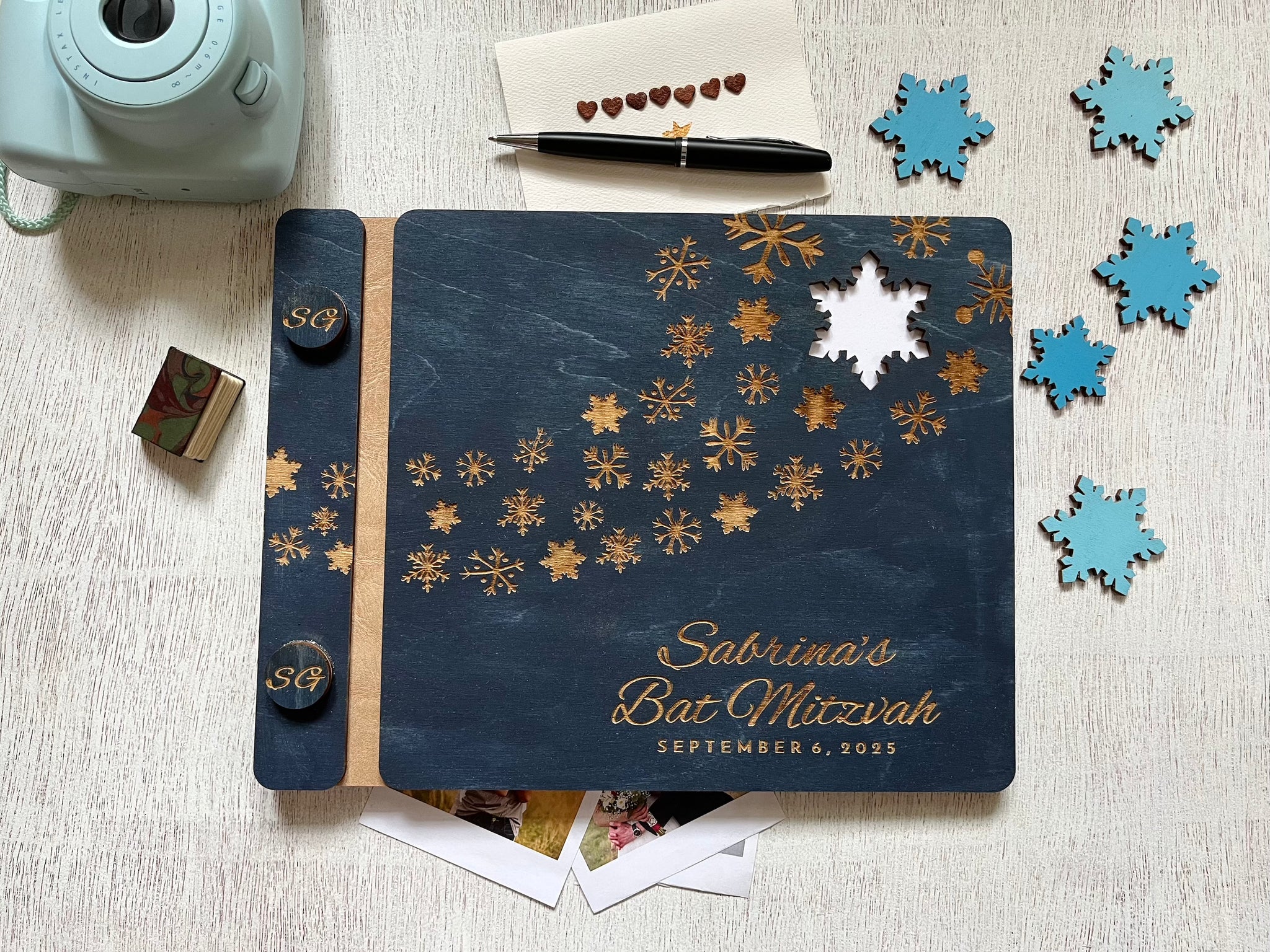 Personalized Bat Mitzvah guest book album with decorative engraved snowflakes on a navy wooden cover