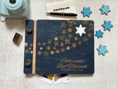 Personalized Bat Mitzvah guest book album with decorative engraved snowflakes on a navy wooden cover