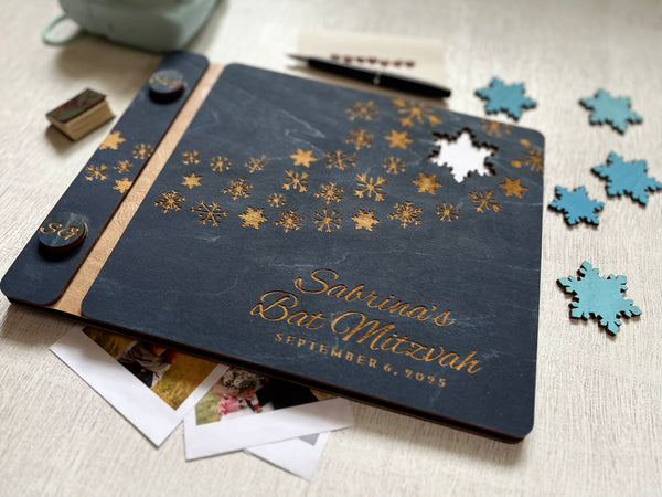 Personalized Bat Mitzvah guest book album with decorative engraved snowflakes on a navy wooden cover