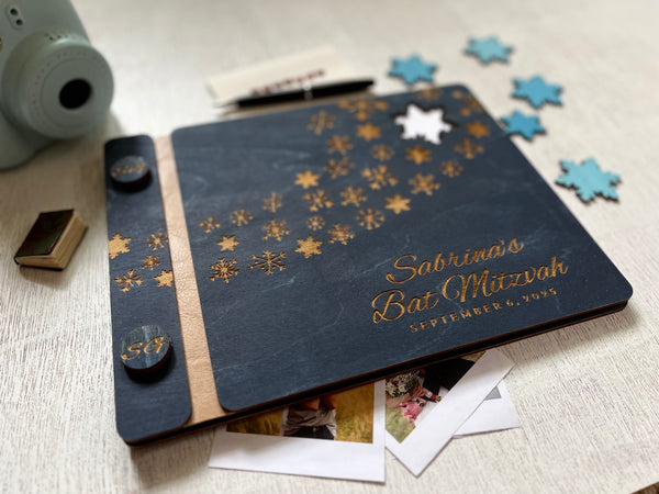 Personalized Bat Mitzvah guest book album with decorative engraved snowflakes on a navy wooden cover