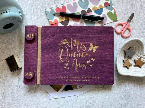 Mis Quince anos quinceañera guest book with purple stain wooden covers and engraved with personalized text and a princess crown and butterflies