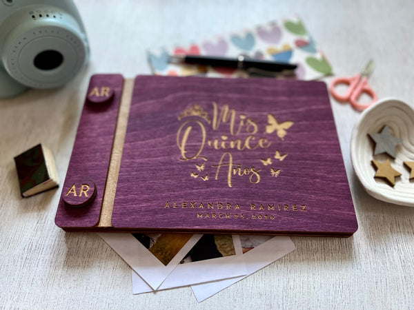 Mis Quince anos quinceañera guest book with purple stain wooden covers and engraved with personalized text and a princess crown and butterflies