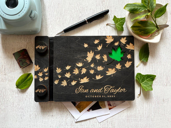 Personalized wedding guest book album with maple leaf design and engraved names and wedding date  