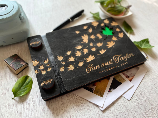 Personalized wedding guest book album with maple leaf design and engraved names and wedding date  