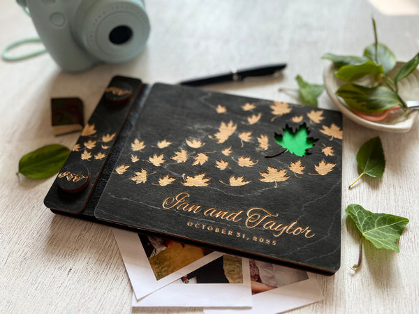 Personalized wedding guest book album with maple leaf design and engraved names and wedding date  