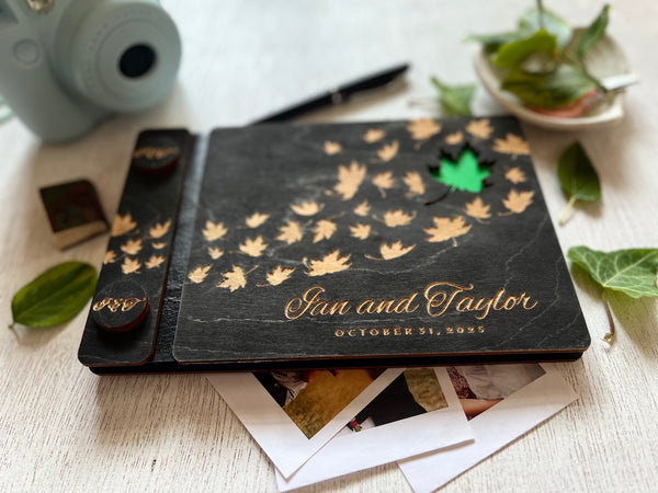 Personalized wedding guest book album with maple leaf design and engraved names and wedding date  