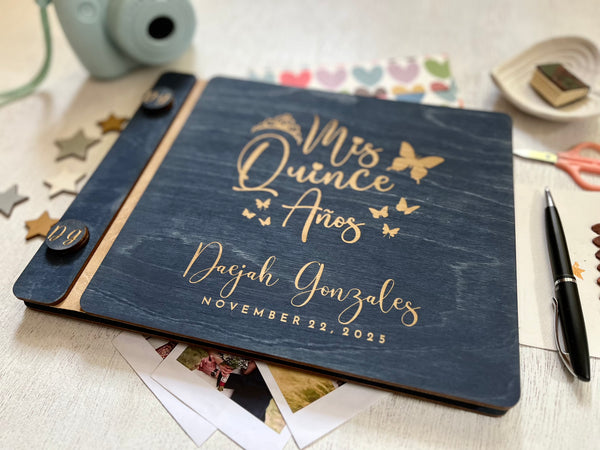 Personalized 'Mis Quince Años' album with engraved text on a decorative background with butterfly motif